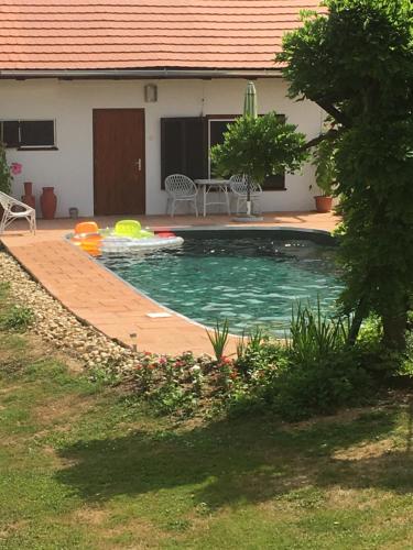 a swimming pool in the backyard of a house at Noé Bárkája Vendégház in Nagyrákos