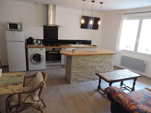 a kitchen with a counter and a stove top oven at Les Lavandes d'Estoublon in Estoublon