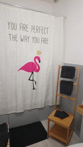 a wall with a pink flamingo sign on it at Studio cosy proche Gare in Libourne