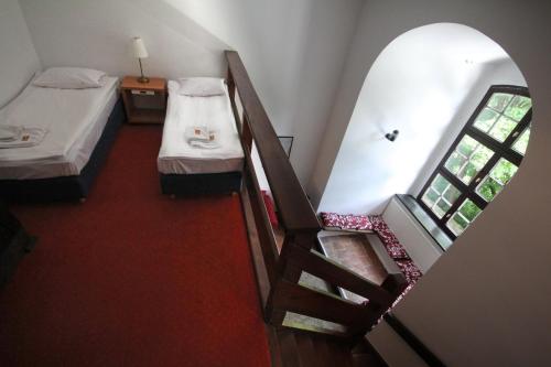 a small room with two beds and a staircase at Zamek Reszel in Reszel