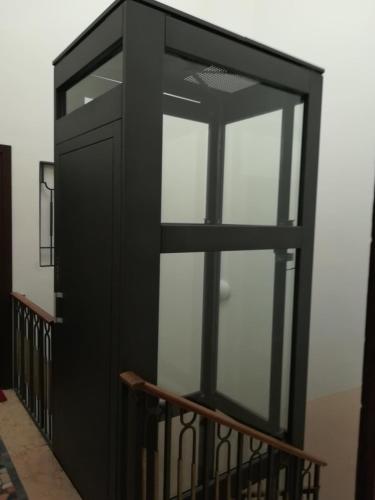 a black cabinet with glass doors in a room at Residenza San Pietro in Vicenza