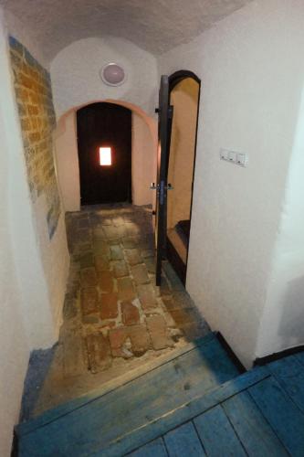 a hallway leading to a door in a building at Zamek Reszel in Reszel