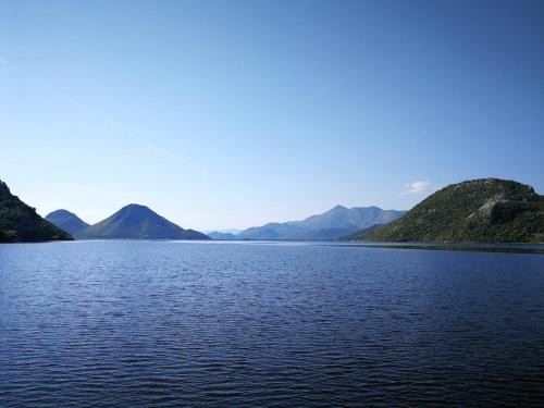 a large body of water with mountains in the background at Ethno Lodge AB in Virpazar