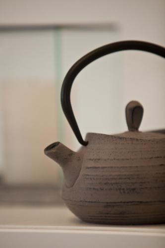 a tea pot sitting on top of a table at Sun 'n Chill, Boutique Apartments & Beach Villa in Melíkia