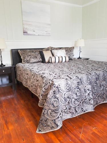 a bedroom with a large bed with pillows on it at Blackbeard's Lodge in Ocracoke