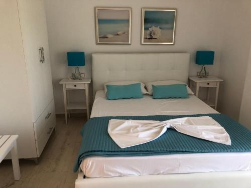 a bedroom with a bed with a bow on it at Spyridonou House in Parga