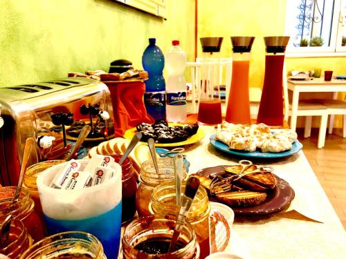 a table topped with plates of food and drinks at Sant'Agostino Suites & Rooms in Mazara del Vallo