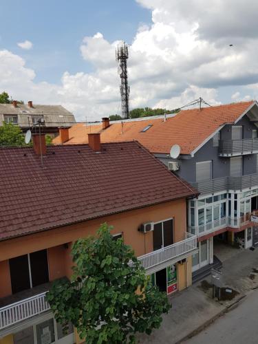 a group of buildings with a tower in the background at Stan 110 in Orašje
