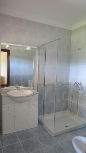a bathroom with a shower and a sink and a tub at Casa das Oliveiras in Beiral do Lima