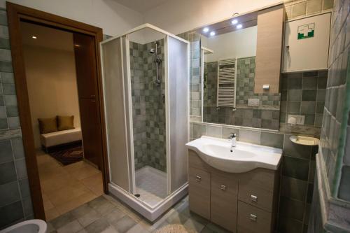 a bathroom with a sink and a shower at Asher's House Colosseum in Rome