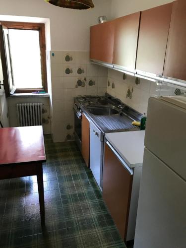 a small kitchen with a sink and a refrigerator at Hameau De Jadis in Pré-Saint-Didier