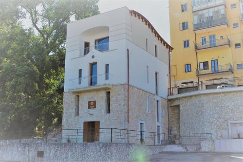 a white building next to some buildings at Bora B&B in Troia