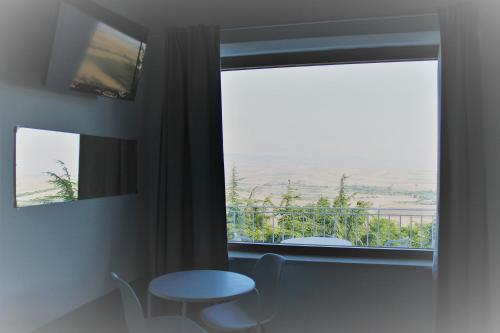 a room with a table and a window with a view at Bora B&B in Troia
