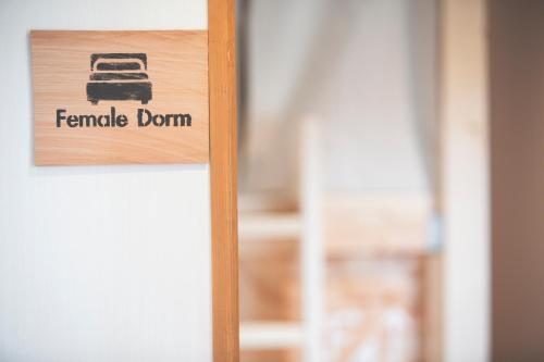 a sign on a door that reads female dorm at Noboribetsu Guest House AKA & AO in Noboribetsu