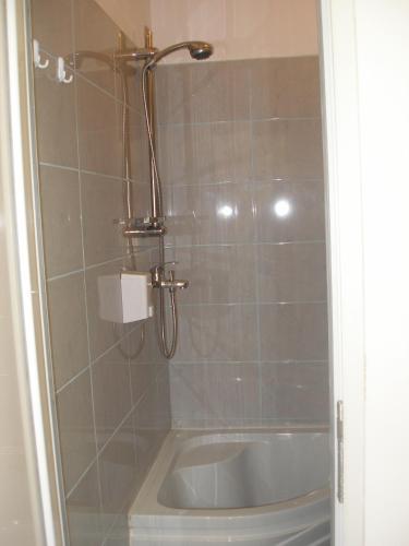 a bathroom with a shower and a bath tub at Kretan Hostel in Bucharest