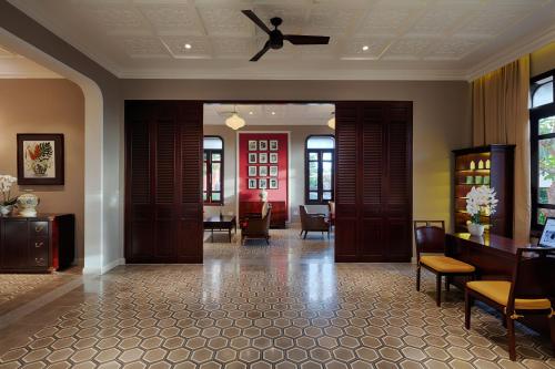 a lobby with doors and chairs and a ceiling fan at Allegro Hoi An . A Little Luxury Hotel & Spa in Hoi An