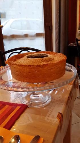 a cake sitting on a glass plate on a table at La Casa Del Grillo 1 in Aosta