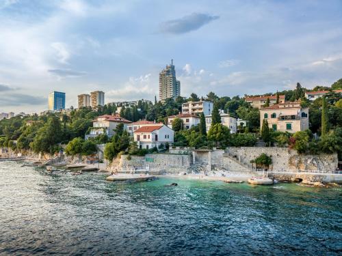 a view of a river with buildings and a city at Volcano Rijeka in Rijeka
