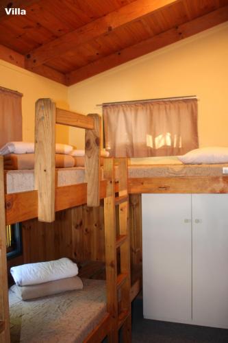 a room with two bunk beds in a cabin at Lani's Holiday Island in Forster
