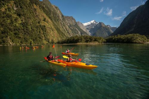 a group of people in kayaks on a river at Bella Vista Motel Te Anau in Te Anau