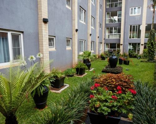 a courtyard with plants and flowers in a building at Best Western Nairobi Upper Hill in Nairobi