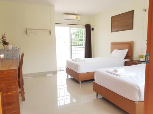 Ein Bett oder Betten in einem Zimmer der Unterkunft Kanlaya House Resort