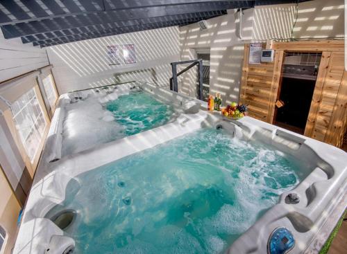 a large hot tub in the middle of a room at Siesta in Achziv in Nahariyya