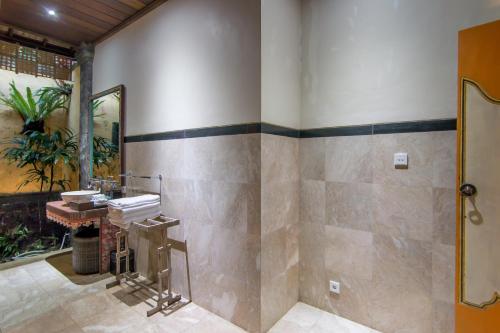 a bathroom with a sink and a mirror at Bidadari Private Villas & Retreat in Ubud