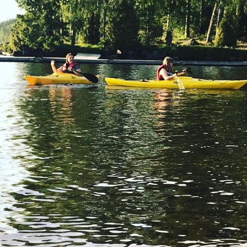 two people in yellow kayaks on a lake at Frykenbadens Camping & Resort in Kil