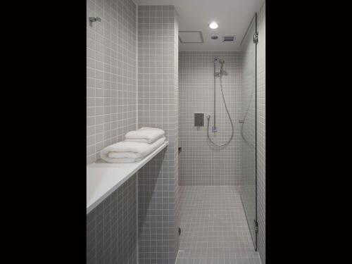 a bathroom with a shower stall and a toilet at nine hours Akasaka sleep lab in Tokyo