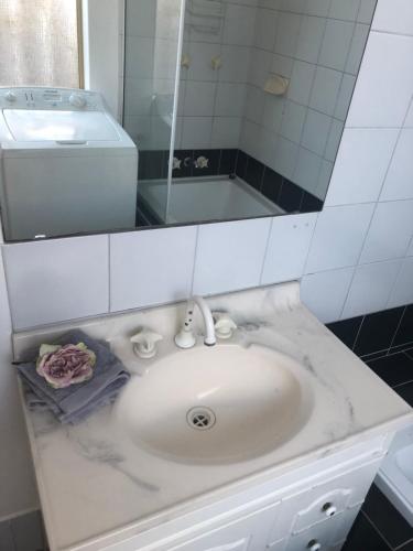 a bathroom with a sink and a mirror at Dampier House Mullaloo-Perth in Perth