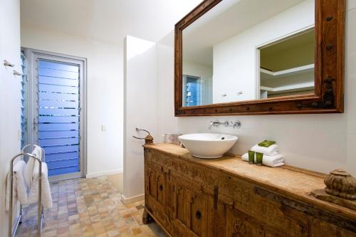 a bathroom with a sink and a mirror at On The Deck at Sunshine Beach in Noosa Heads