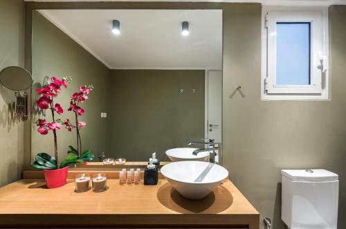 a bathroom with a bowl sink and a mirror at Kolonaki Square Apartment in Athens