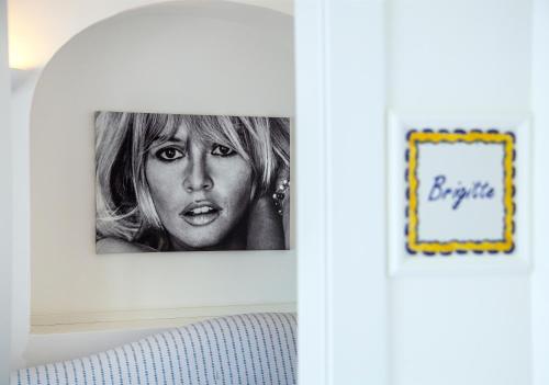 a picture of a woman hanging on a wall at Villa Patrizi in Capri