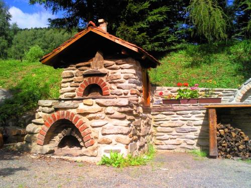a stone oven with a roof on top of it at Penzion Vanessa in Lipova Lazne