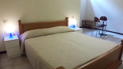 a bedroom with a large bed with two lamps on tables at Hotel Firenze 2000 in Florence
