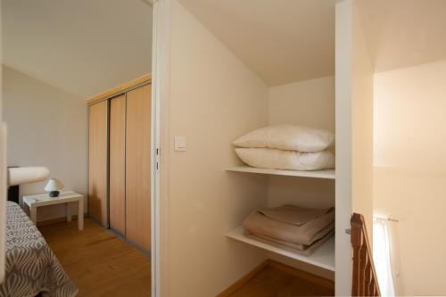 a room with a closet with pillows on shelves at Residence Agula Mora in Lecci