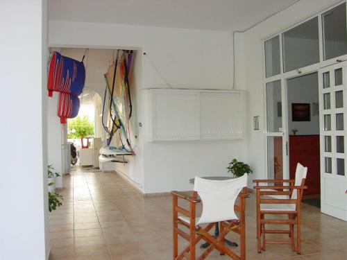 a living room with a table and chairs in it at Glaros Studios in Loutra Edipsou