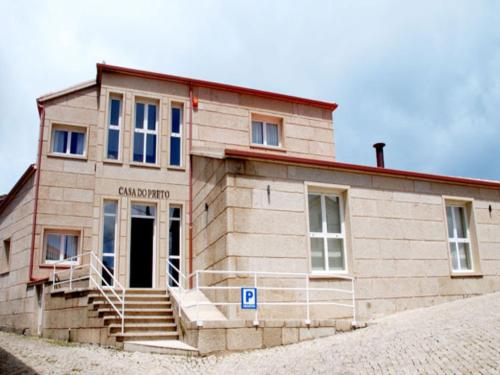 a small building with a staircase in front of it at Casa do Preto in Pitões das Júnias