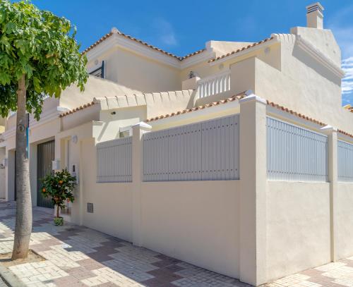 a white fence in front of a house at Petit Malaga Congress in Málaga