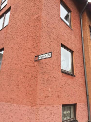 a street sign on the side of a brick building at DG Rechts 108A 2 Zimmer Apartment Dachgeschoss in Holzminden