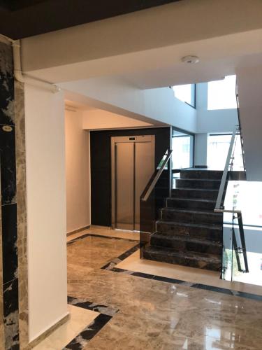 a hallway with stairs leading to a door at Luxury Apartment Sophia 3 - DaviDary in Mamaia