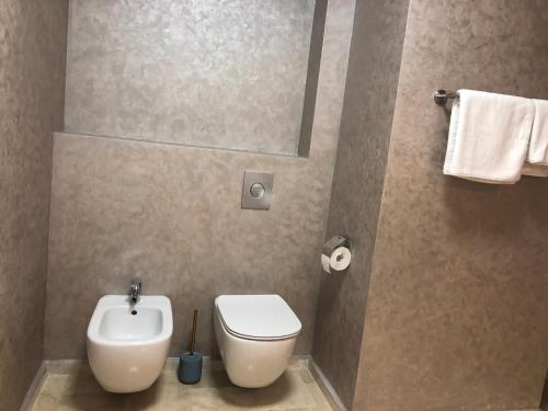 a bathroom with a toilet and a sink at Luxury Apartment Sophia 3 - DaviDary in Mamaia