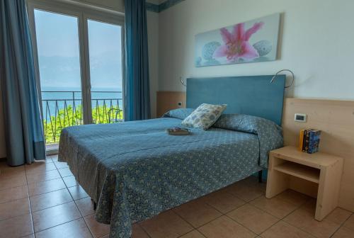 Postel nebo postele na pokoji v ubytování Hotel Residence Sirenella