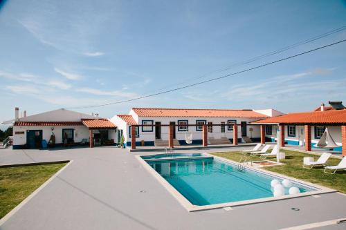 an image of a villa with a swimming pool at Zulla Nazaré`s Surf Village in Nazaré
