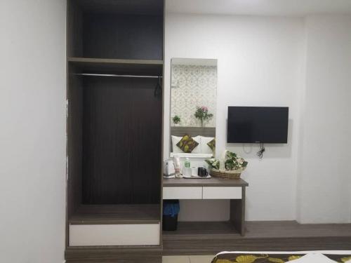 a room with a television and a desk with a monitor at D'Metro Hotel in Shah Alam