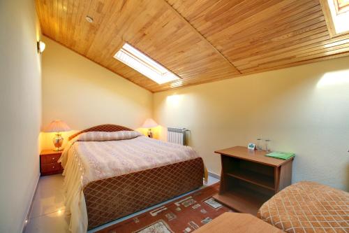 a bedroom with two beds in a room with a skylight at Hotel Aquapark Alligator in Ternopil
