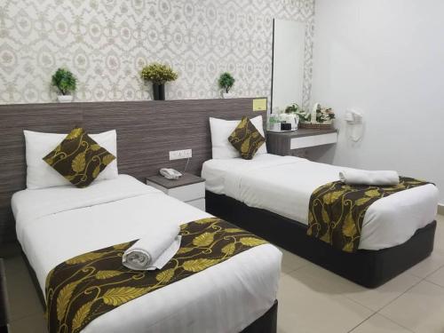 Postel nebo postele na pokoji v ubytování D'Metro Hotel