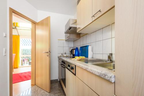 a kitchen with a sink and a counter at Apart Hotel Stadtgarten in Überlingen