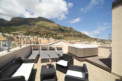 a balcony with chairs and a view of a mountain at Sciabika Home - Edificio Egadi in Castellammare del Golfo